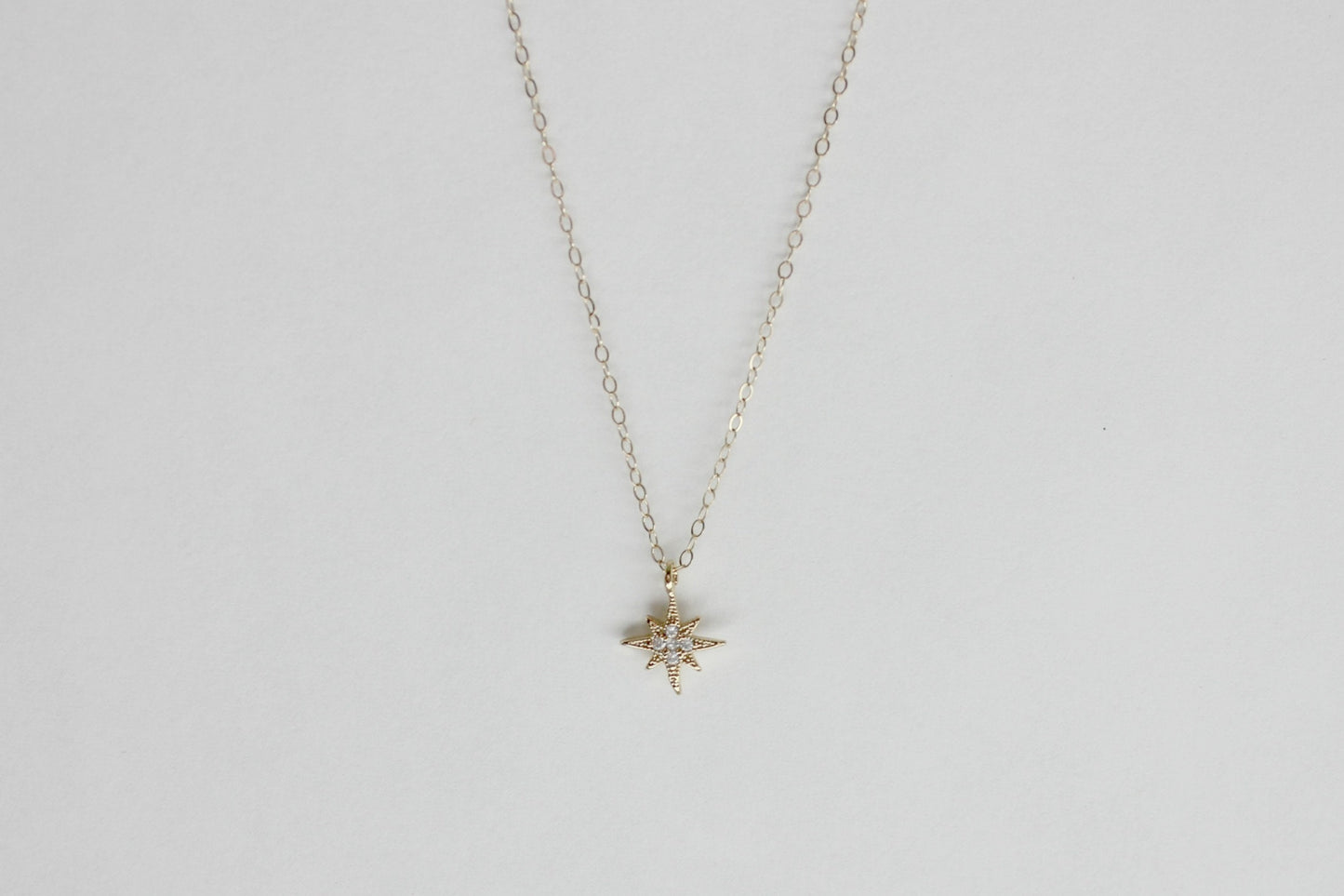 CZ starburst necklace, cz north star pendant, small gold necklace, layering necklace