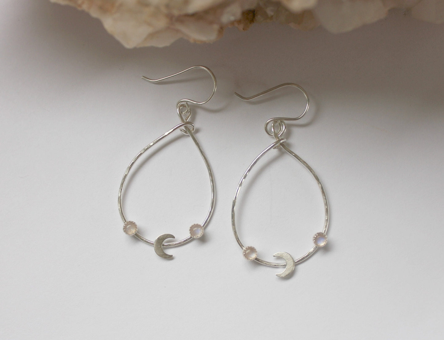 Silver crescent moon hoop earrings with moonstone
