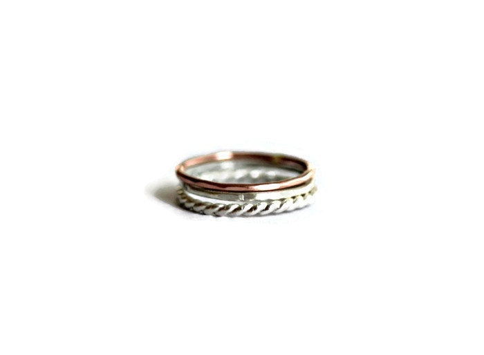 Set of three sterling silver and rose gold stacking rings, silver twist, rose gold and hammered.