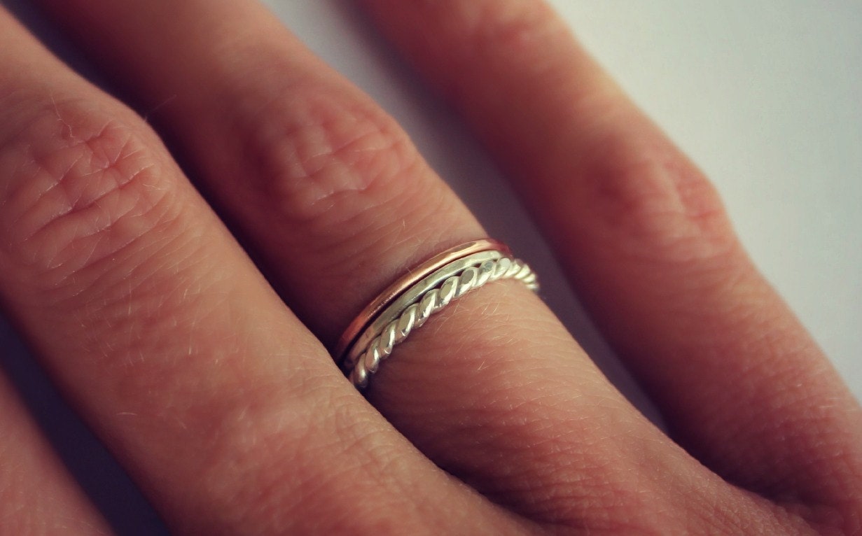 Set of three sterling silver and rose gold stacking rings, silver twist, rose gold and hammered.