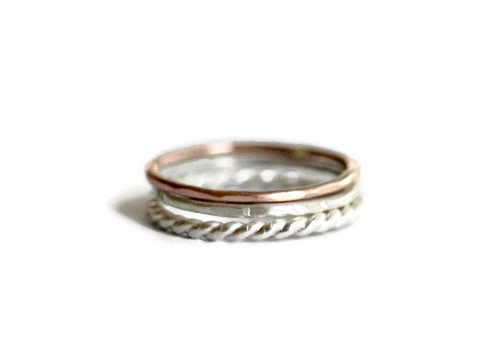 Set of three sterling silver and rose gold stacking rings, silver twist, rose gold and hammered.