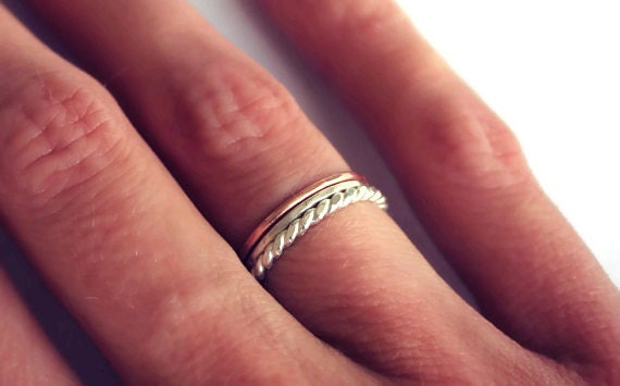 Set of three sterling silver and rose gold stacking rings, silver twist, rose gold and hammered.